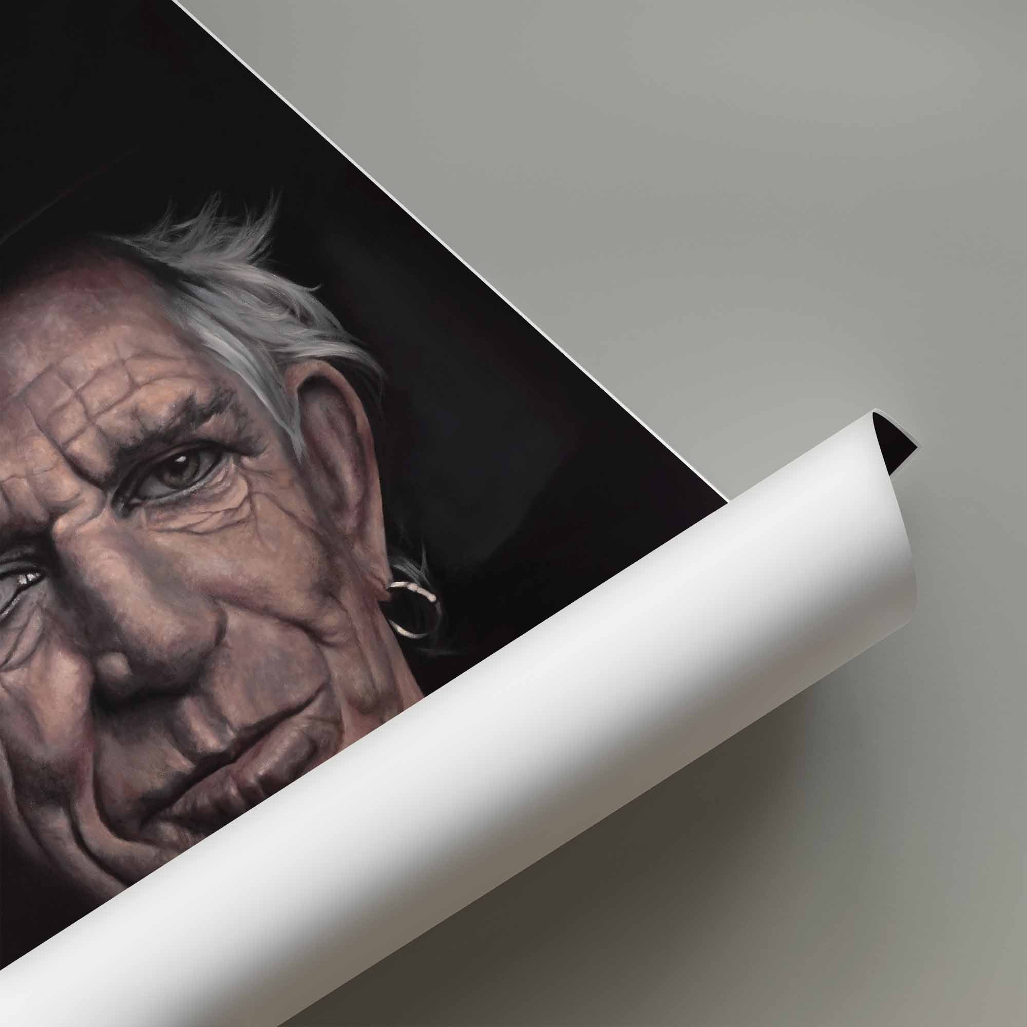 Rolled up poster of a portrait of Keith Richards with a white background