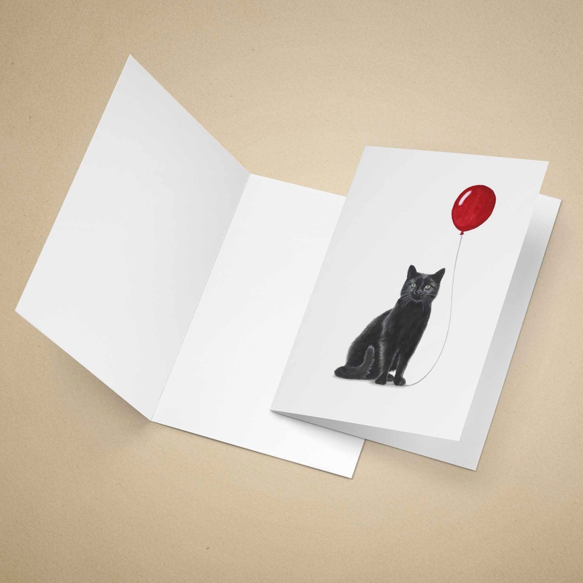 Greeting card with a black cat holding a red balloon on a beige background
