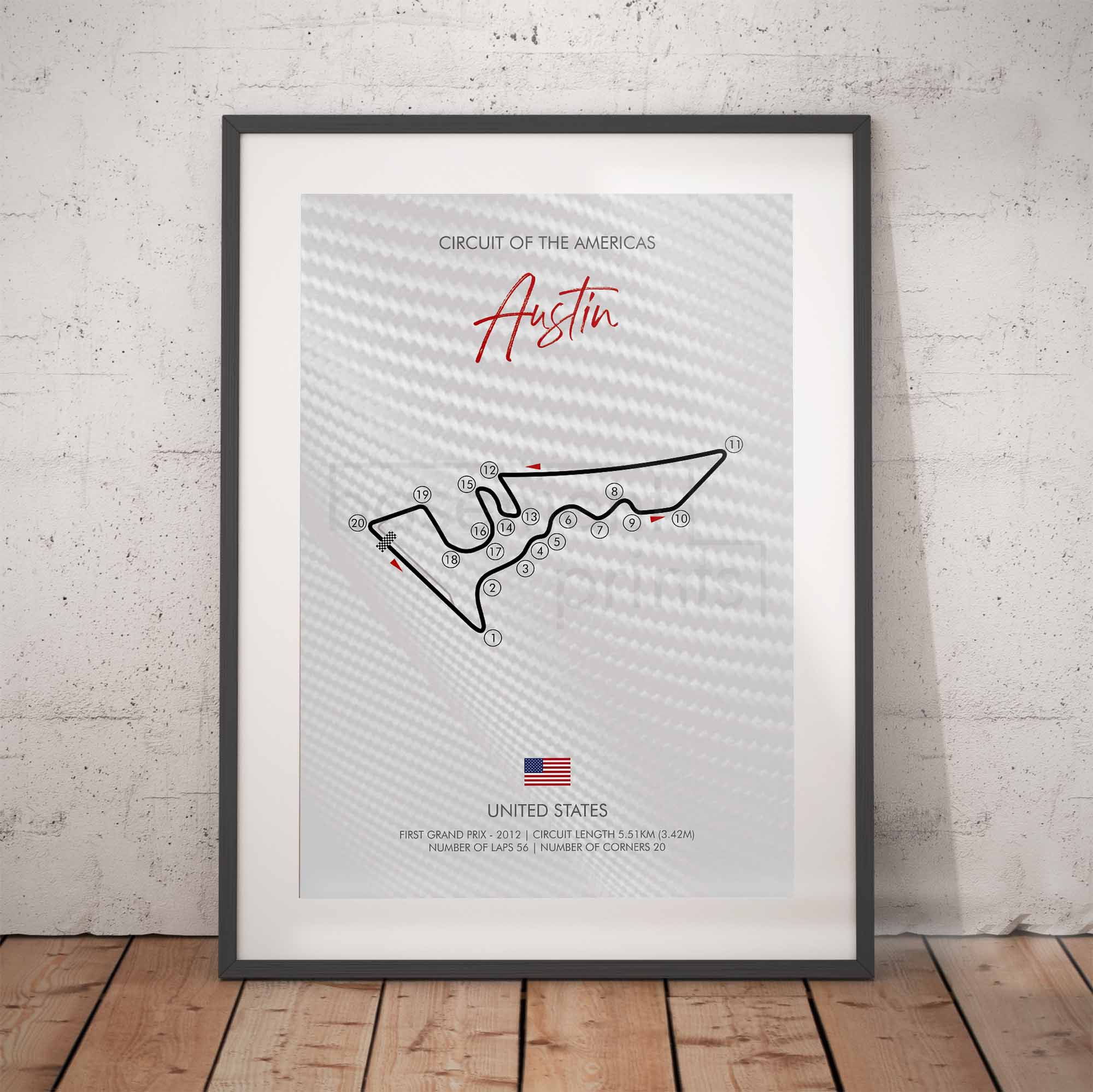 Framed poster of the Circuit of the Americas race track design on a white brick wall.