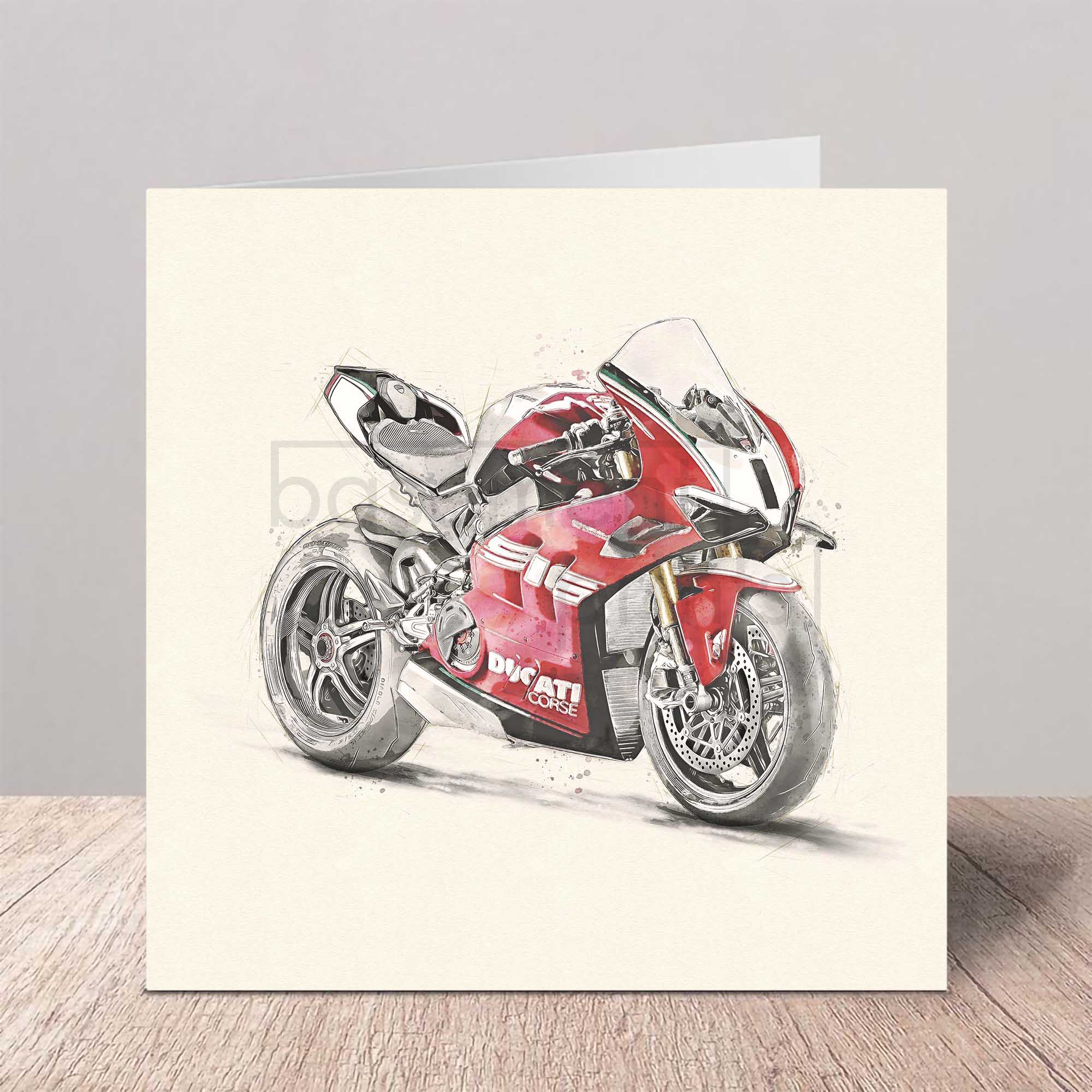 Greeting card with a red Ducati motorcycle illustration on a wooden surface.