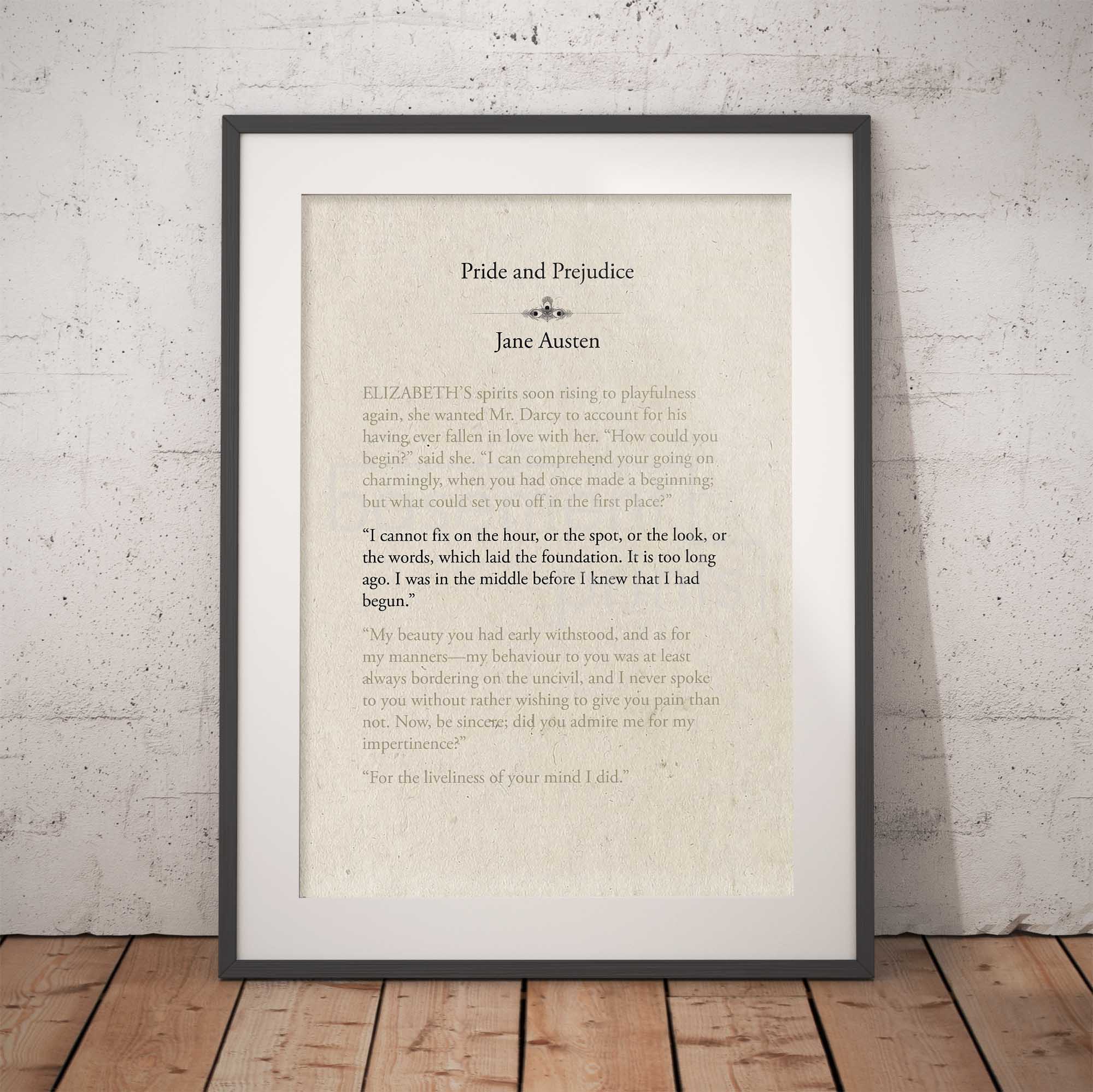 Framed text print of a quote from 'Pride and Prejudice' by Jane Austen against a brick wall.