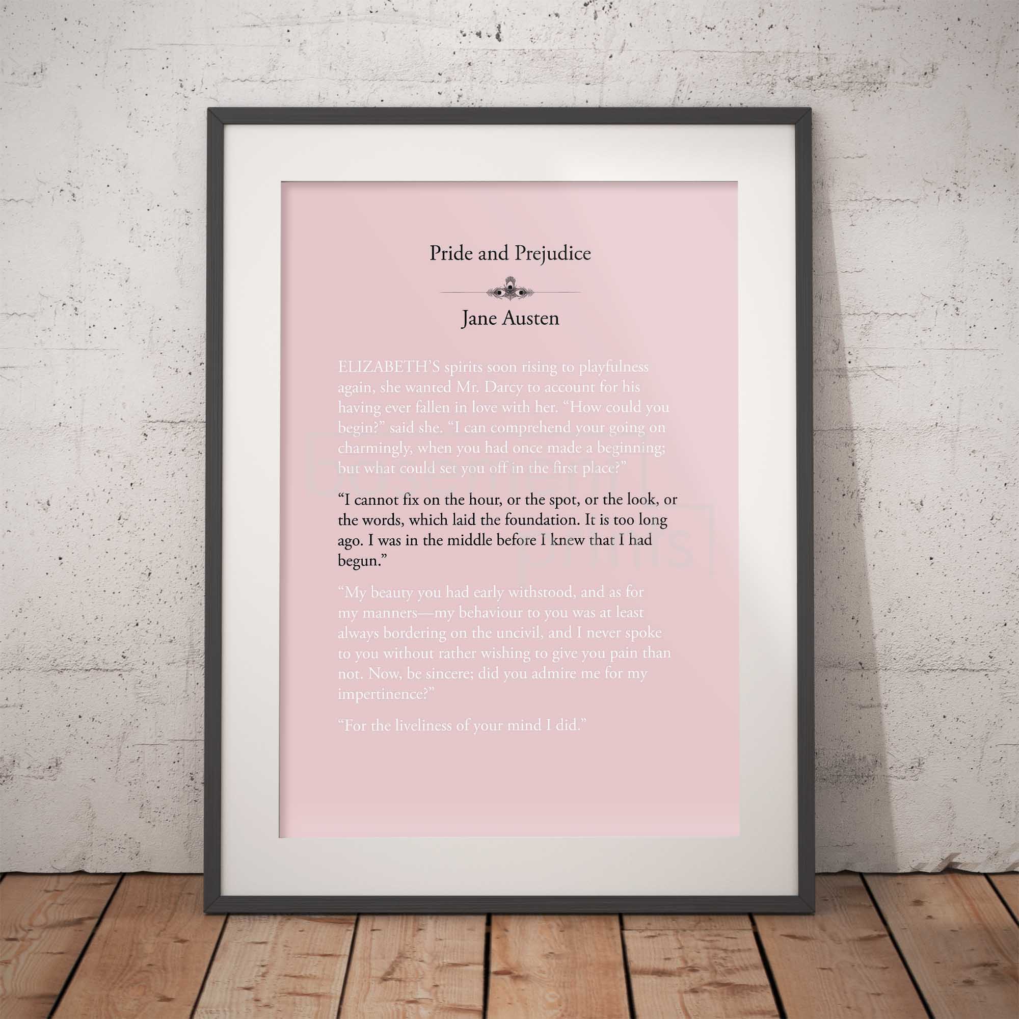 Framed print of 'Pride and Prejudice' by Jane Austen on a pink background against a white brick wall.