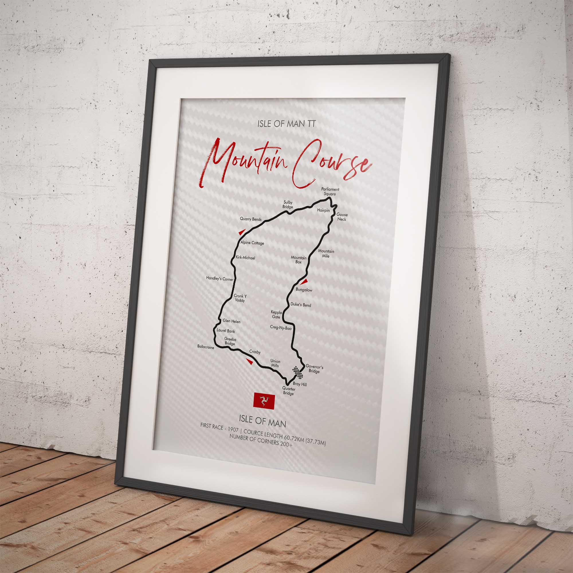 Framed map of the Isle of Man TT Mountain Course on a white brick wall background