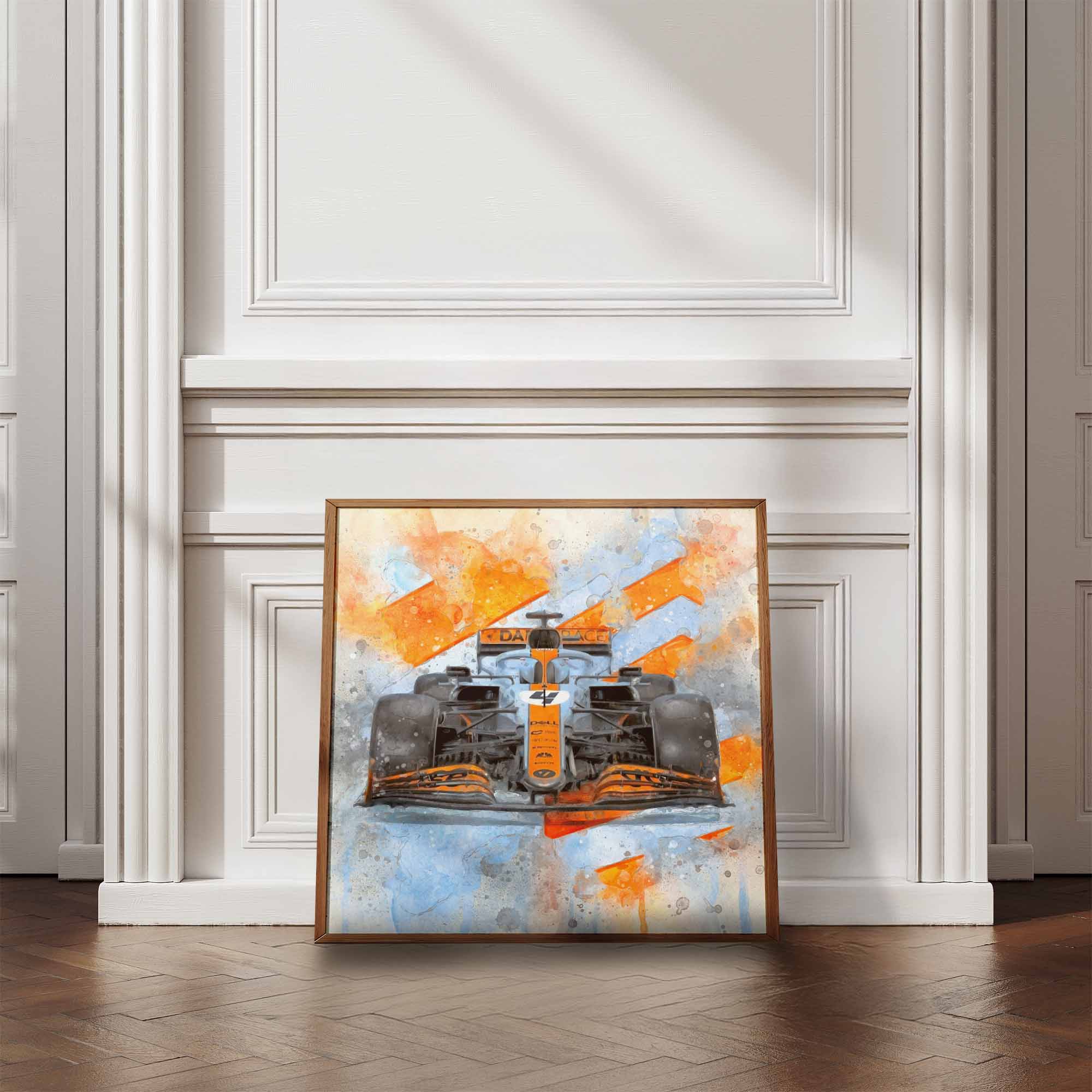 Abstract art of a McLaren F1 car in Gulf Livery with orange and blue colors in a wooden frame on a white wall.