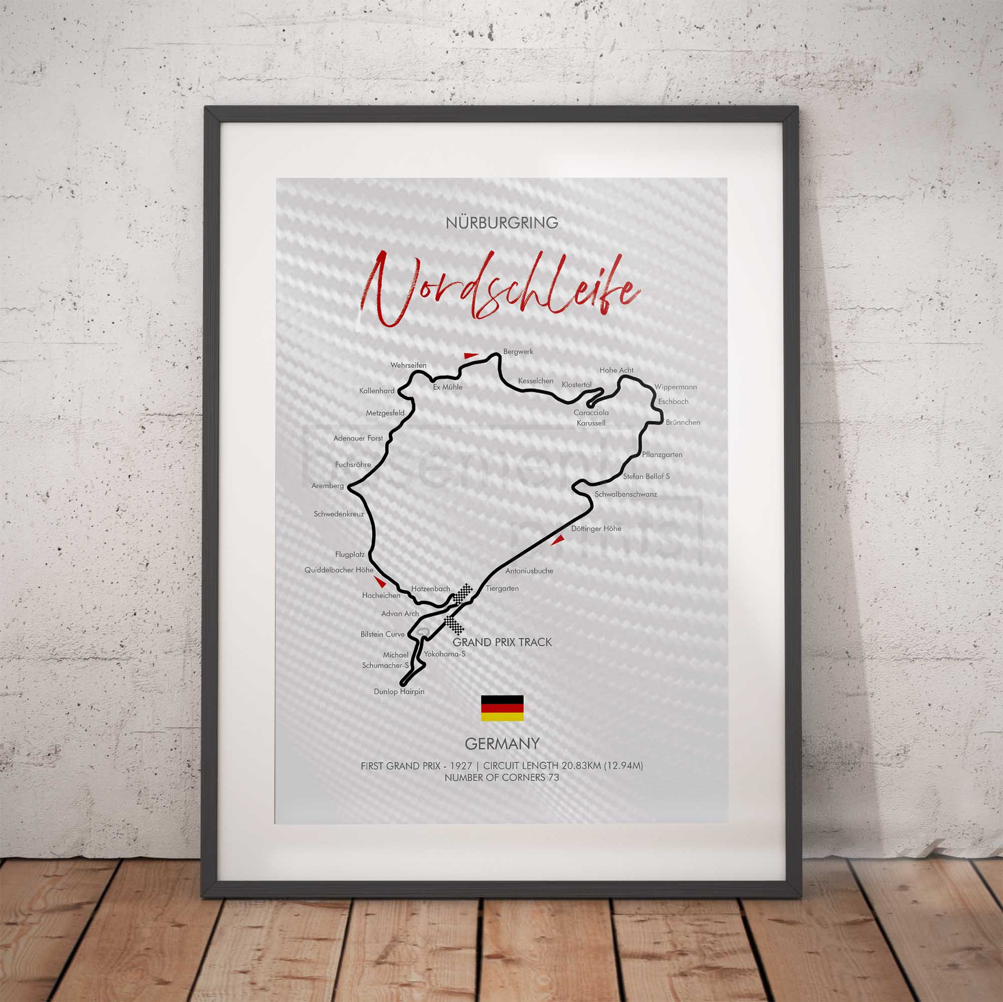 Framed map of Nordschleife race track with German flag on a brick wall background