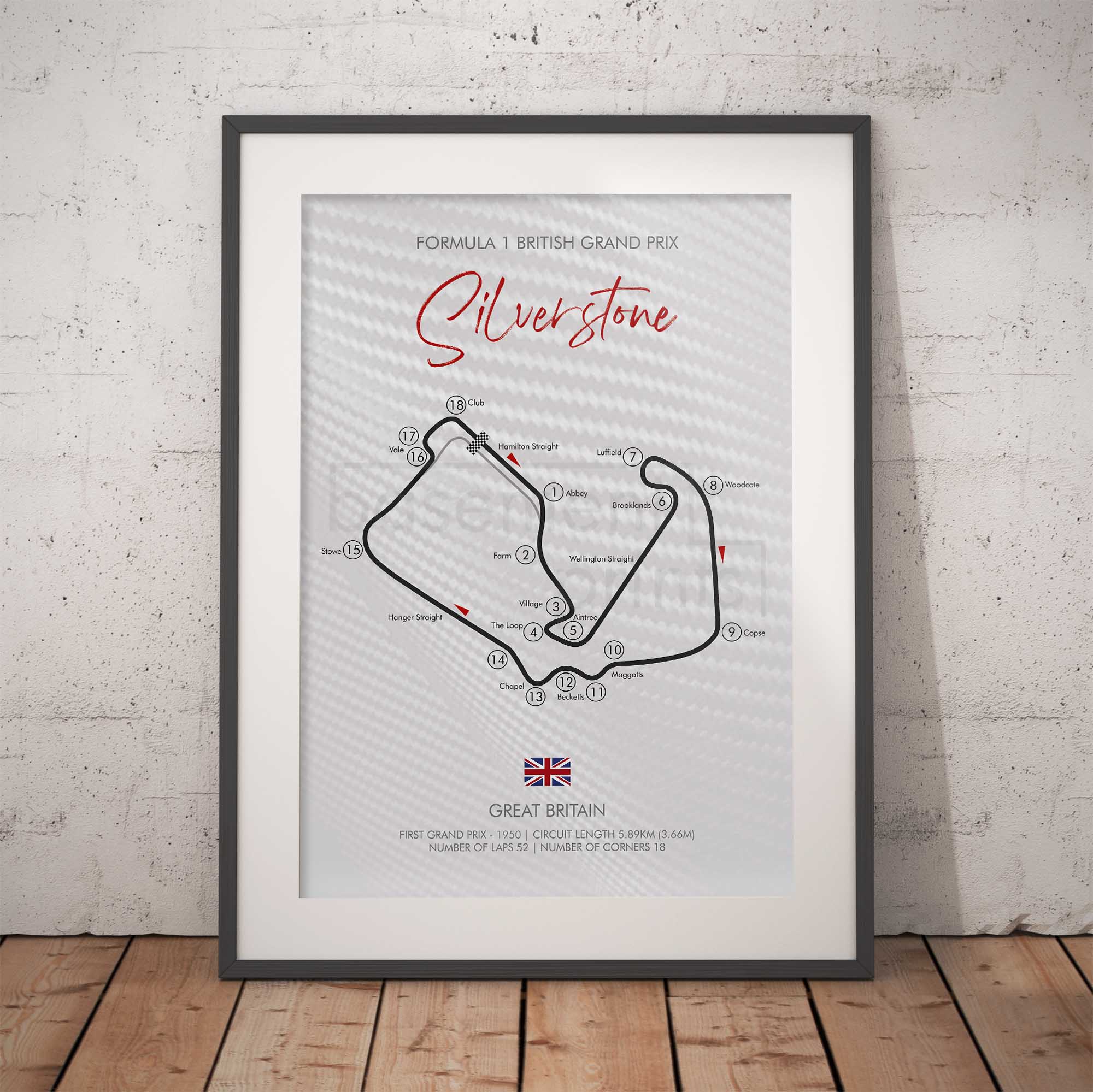 Framed poster of Silverstone circuit layout on a white brick wall background