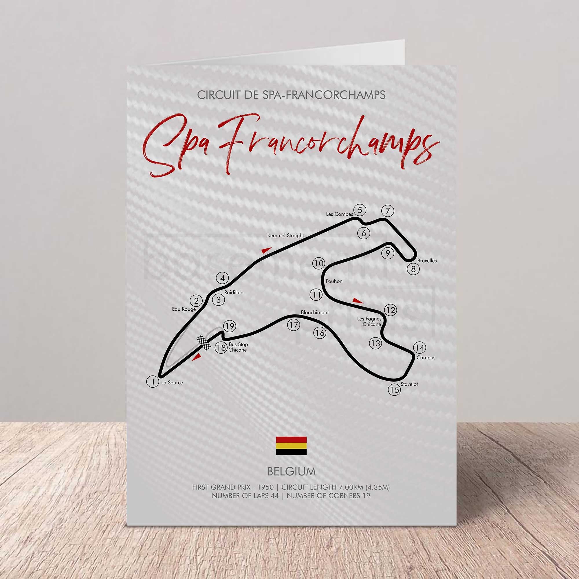 Greetings card of Spa Francorchamps circuit layout with Belgium flag on a wooden surface and light gray background