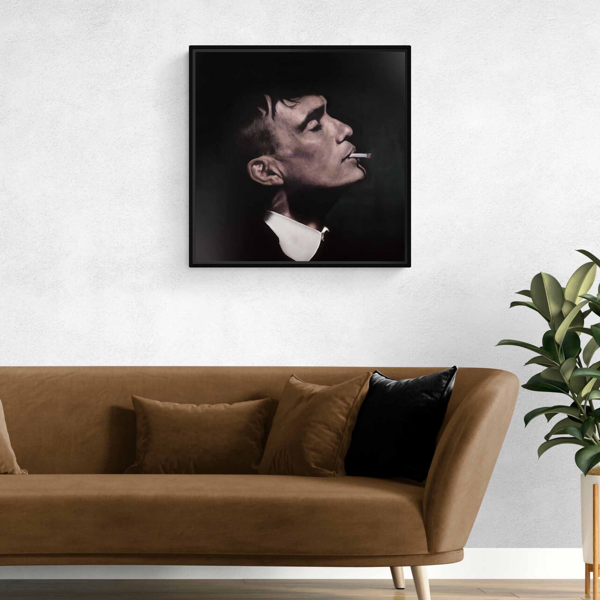 Framed artwork of a man smoking a cigarette on a wall above a brown sofa.
