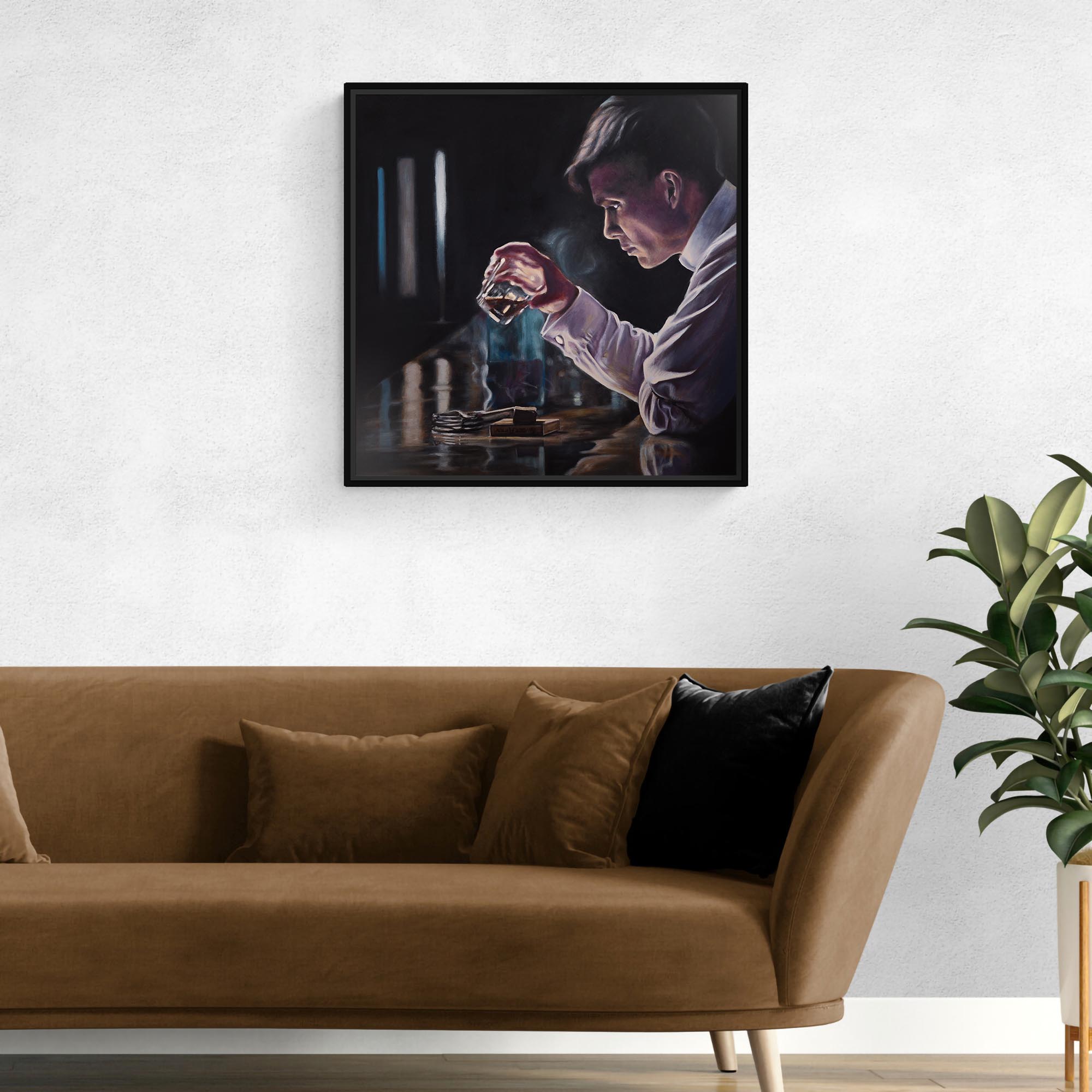 Framed artwork of a person holding a glass above a table with a plant on the right side.