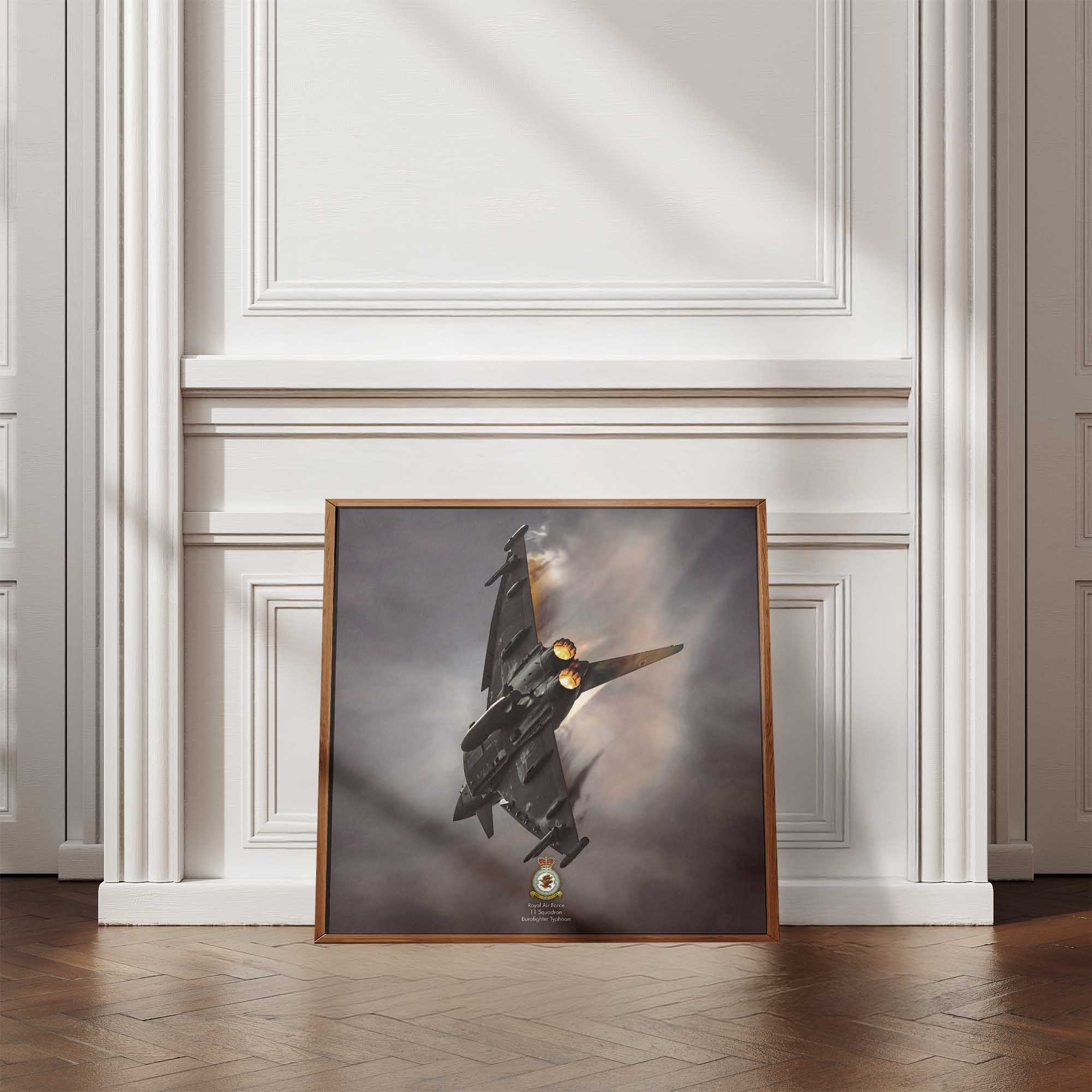 Framed artwork of a fighter jet on a wall with decorative molding.