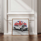Framed artwork of a Daniel Craig leaning against a classic car with a Union Jack design on a white wall.