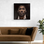 Framed portrait of Anthony Joshua above a brown sofa with decorative pillows in a living room setting.