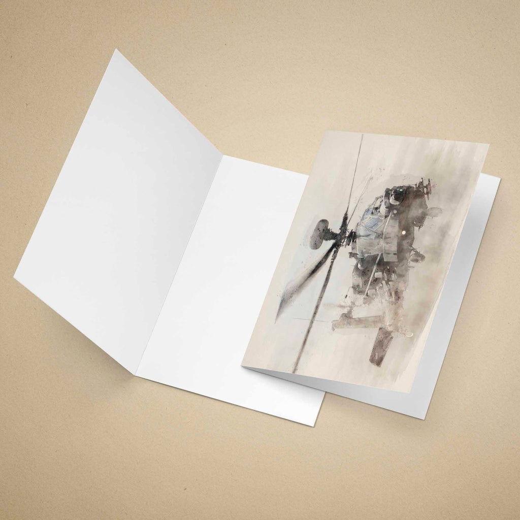 Greeting card with an Apache military helicopter, placed inside an open white card on a beige background.
