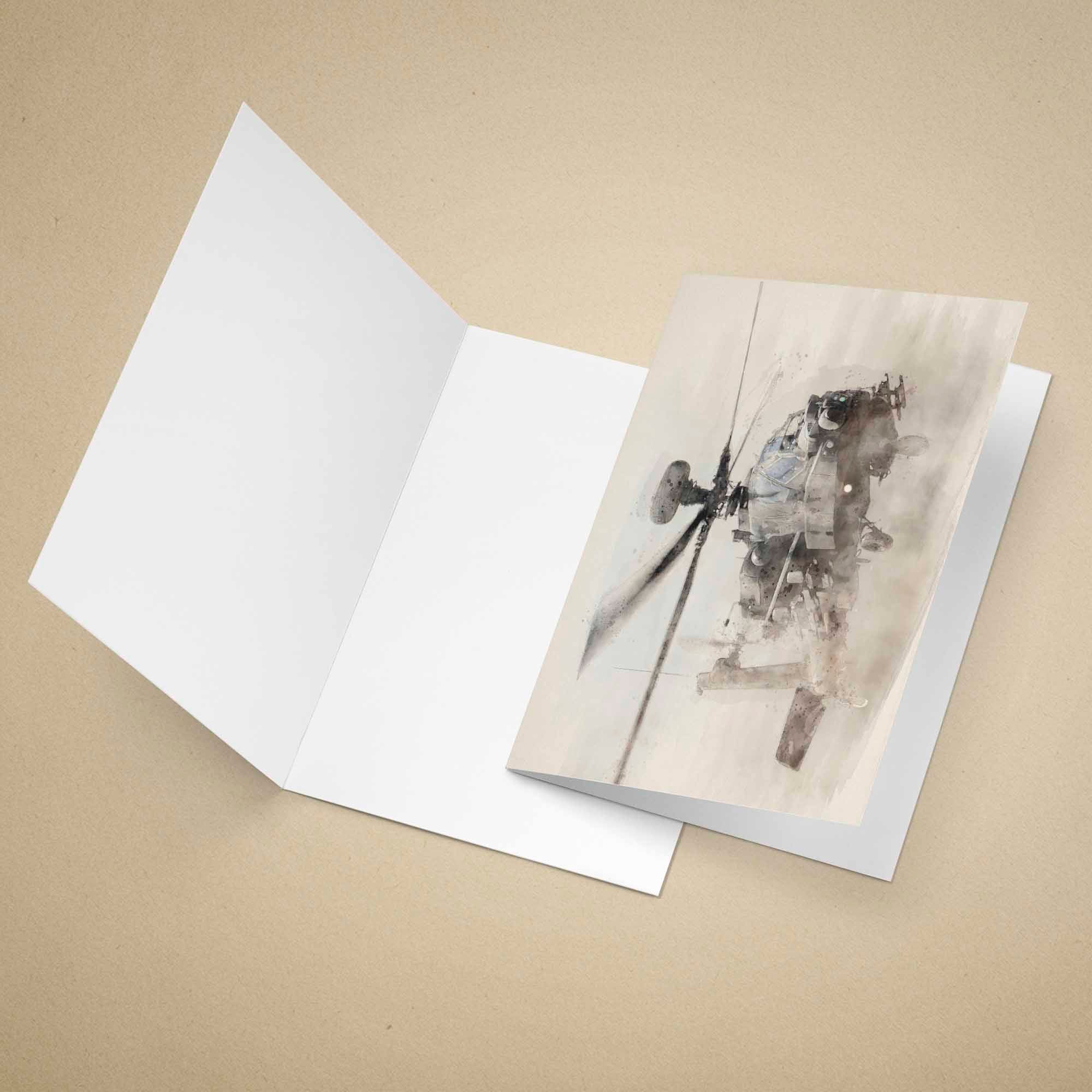 Greeting card with an Apache military helicopter, placed inside an open white card on a beige background.