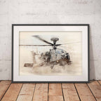 Framed artwork of an Apache helicopter on a wooden floor with a white brick wall background
