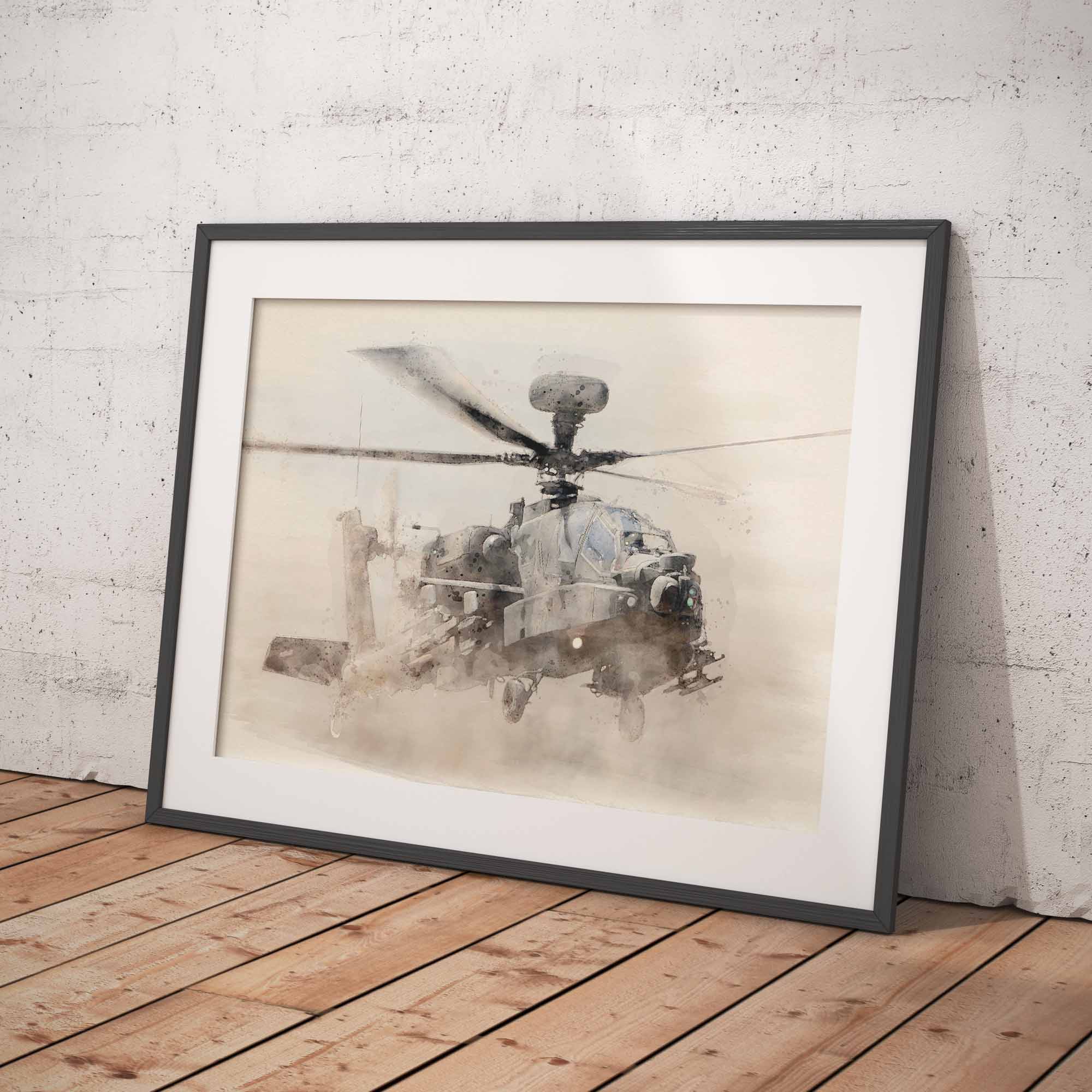 Framed artwork of an Apache helicopter on a wooden floor with a white brick wall background