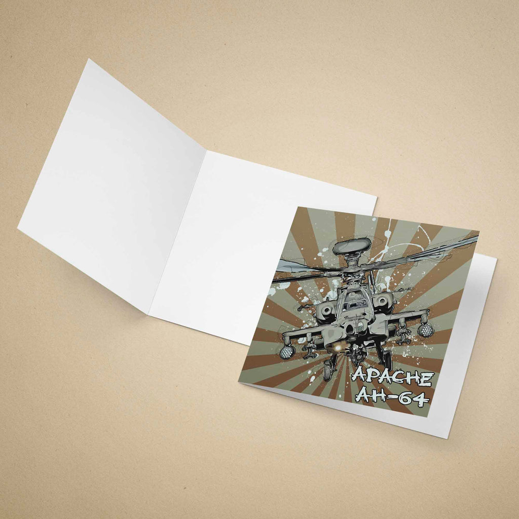 An open white greeting card on a beige background, with the front insert showing a printed illustration of an Apache AH-64 military helicopter over a brown and gray sunburst design with the text 'APACHE AH-64'.