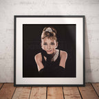 Framed artwork of a stylized portrait of Audrey Hepburn with a black background