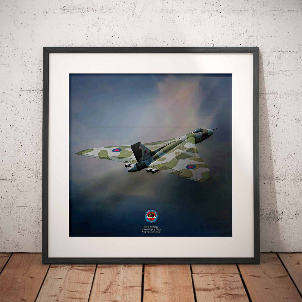 Framed artwork of a Vulcan Bomber against a blue sky on a wooden floor with white brick wall background