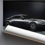 Rolled poster of artwork of James Bonds Aston Martin DB10 on a dark background