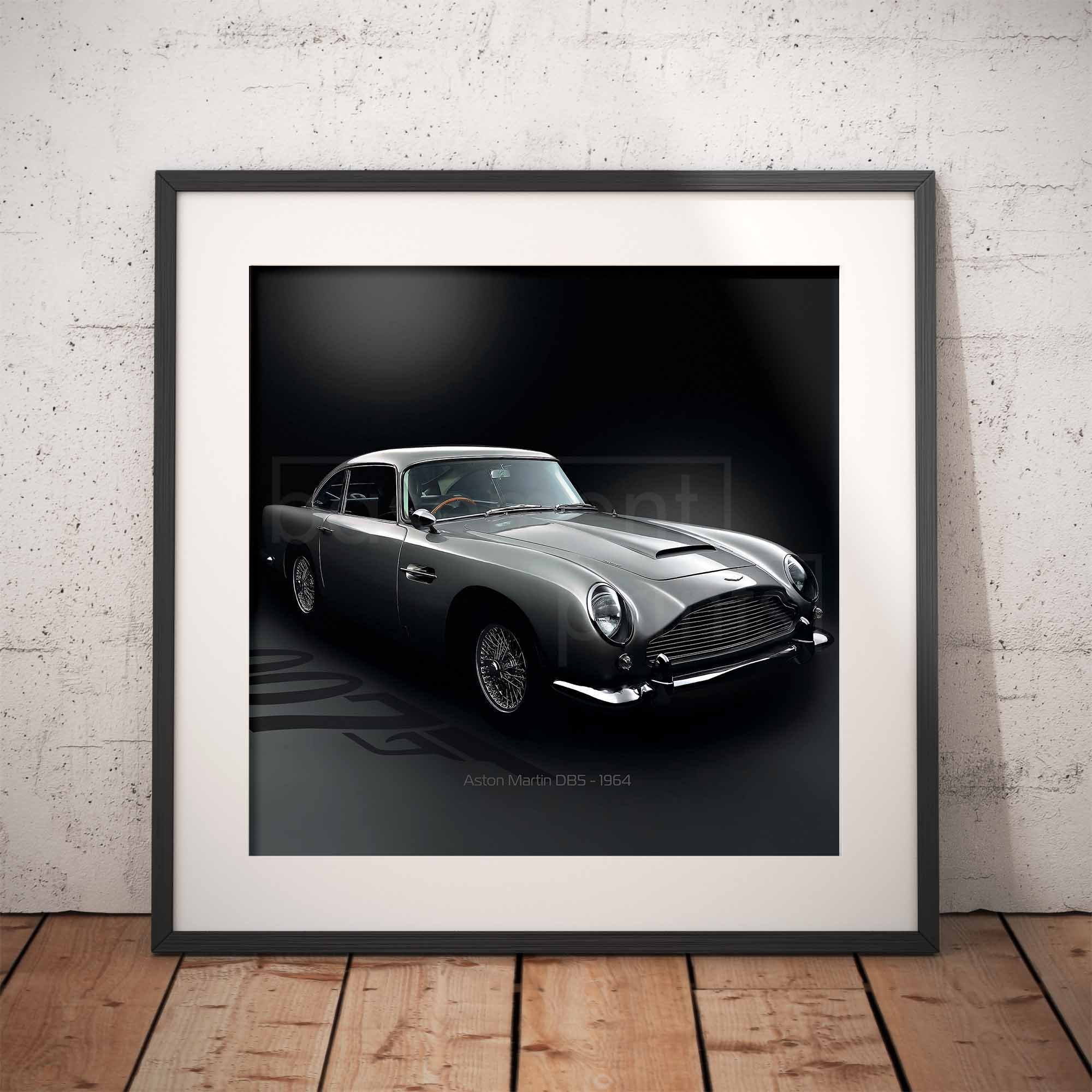 Framed artwork of an Aston Martin DB5 car on a dark background with '007' branding, displayed against a textured wall.