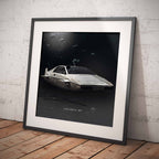 Framed poster of James Bonds Lotus Esprit S1 car on a textured wall.