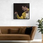 Framed artwork of Freddie Mercury in a yellow jacket on a wall above a brown sofa.