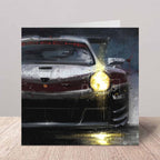 Greeting card with a Porsche 911 Supercup car design on a wooden surface.
