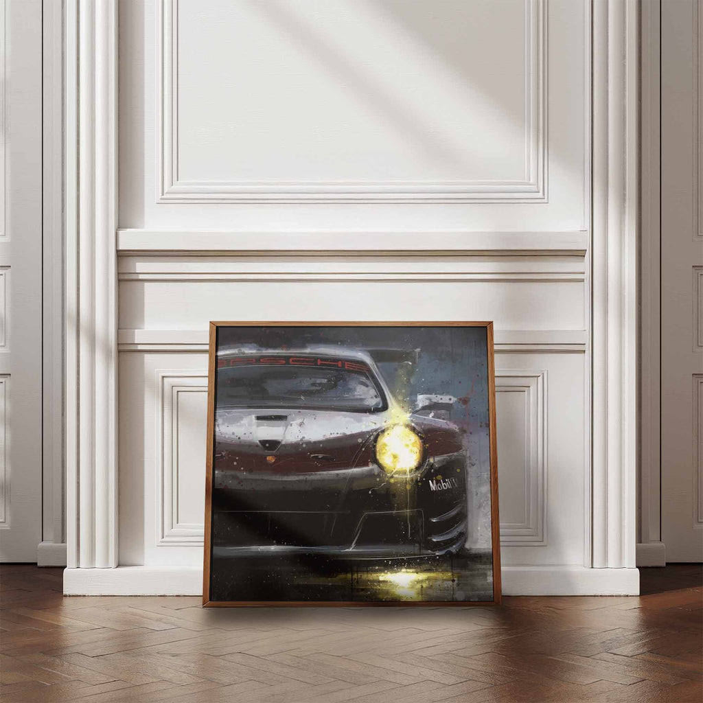 Framed artwork of a Porsche 911 Supercup car on a wall in a room with wooden flooring and white walls.