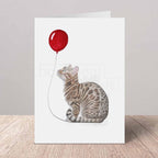 Greeting card with a Bengal cat and red balloon design on a white background