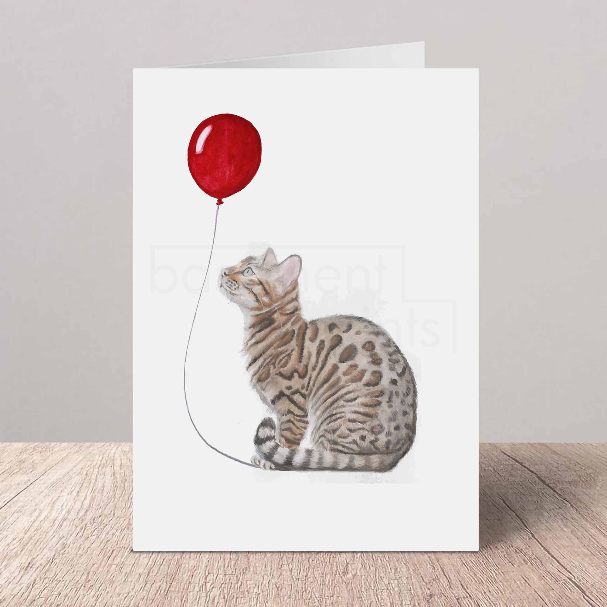 Greeting card with a Bengal cat and red balloon design on a white background