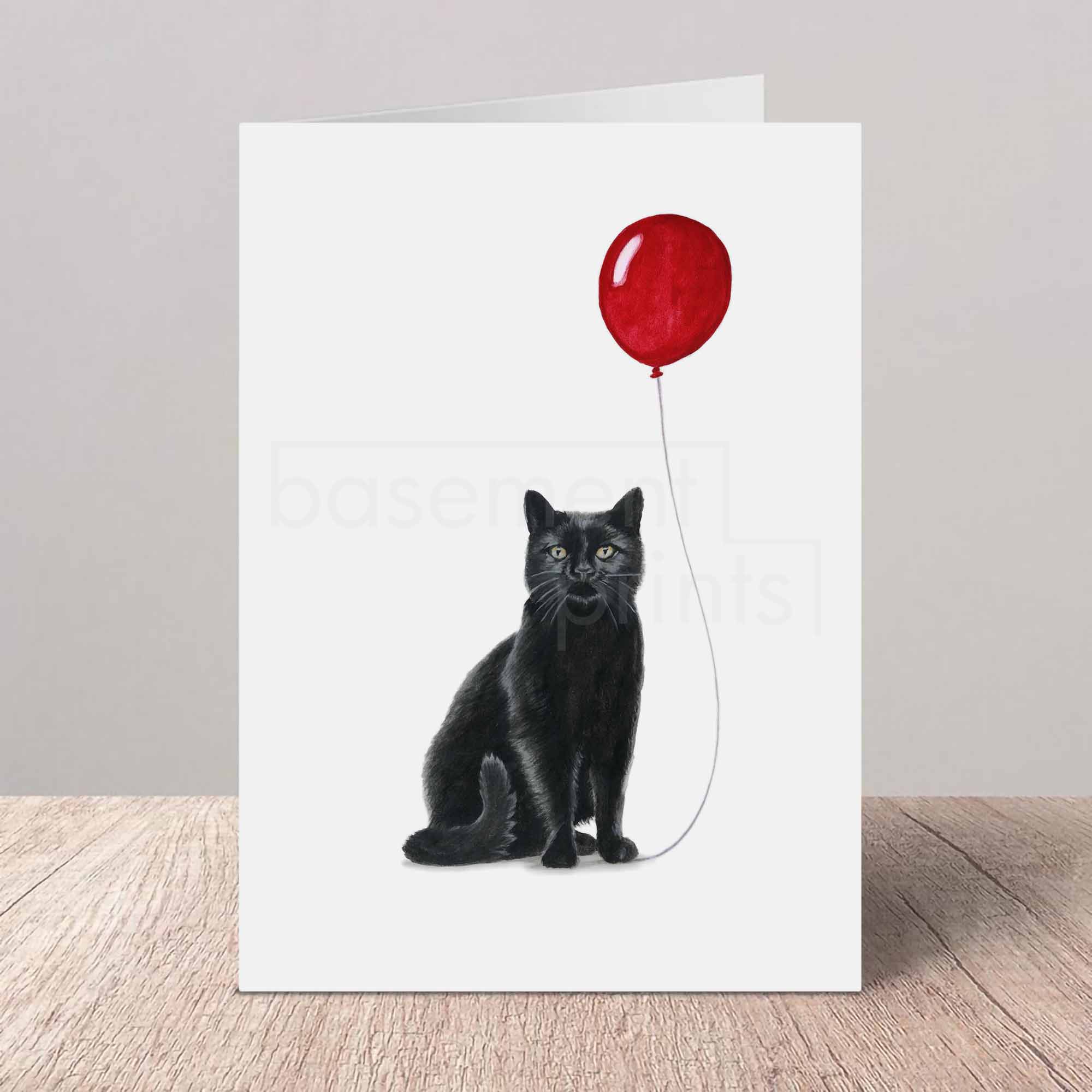 Greeting card with a black cat and red balloon on a white background