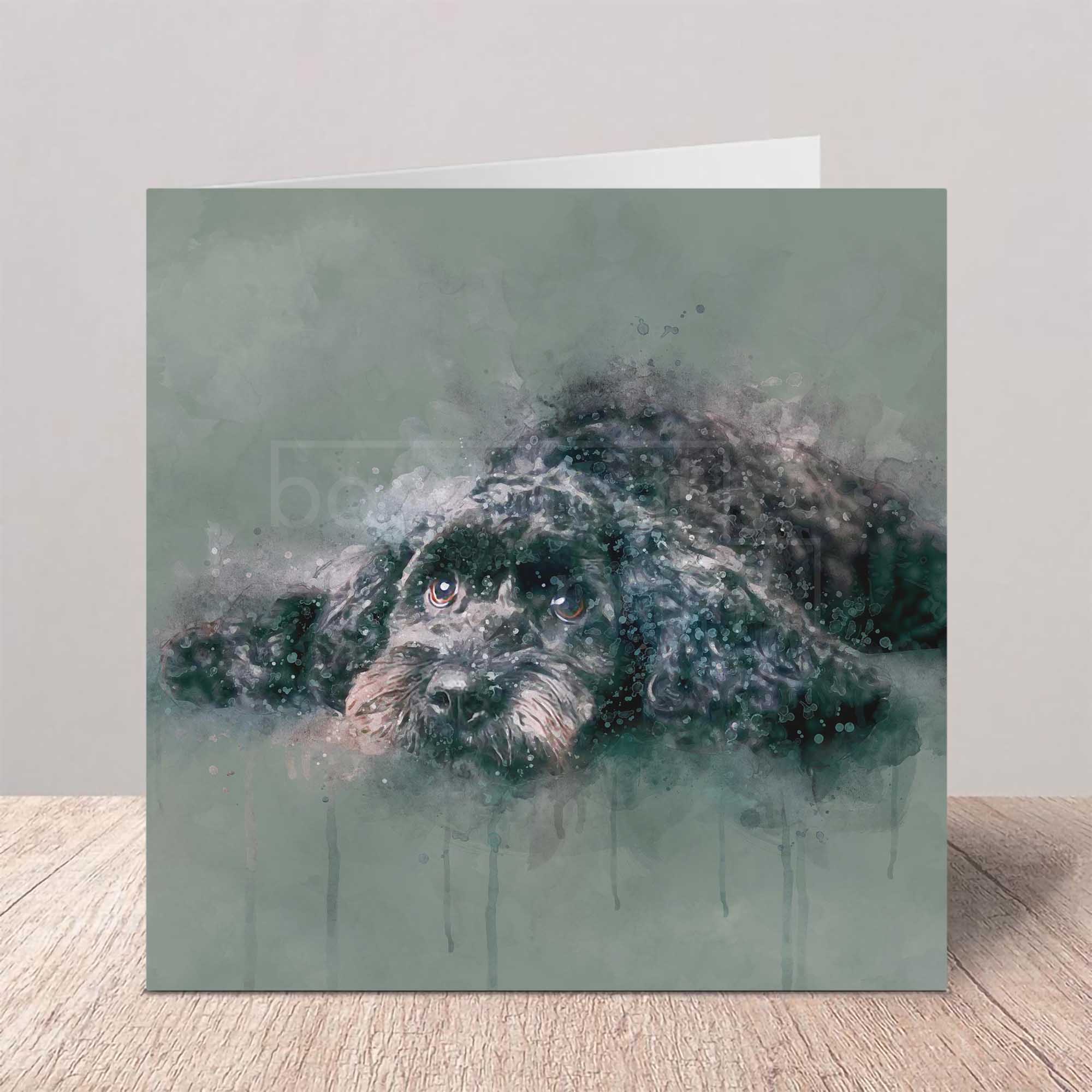 Greeting card with a cockapoo dog in watercolour design on a wooden surface.