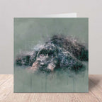 Greeting card with a cockapoo dog in watercolour design on a wooden surface.