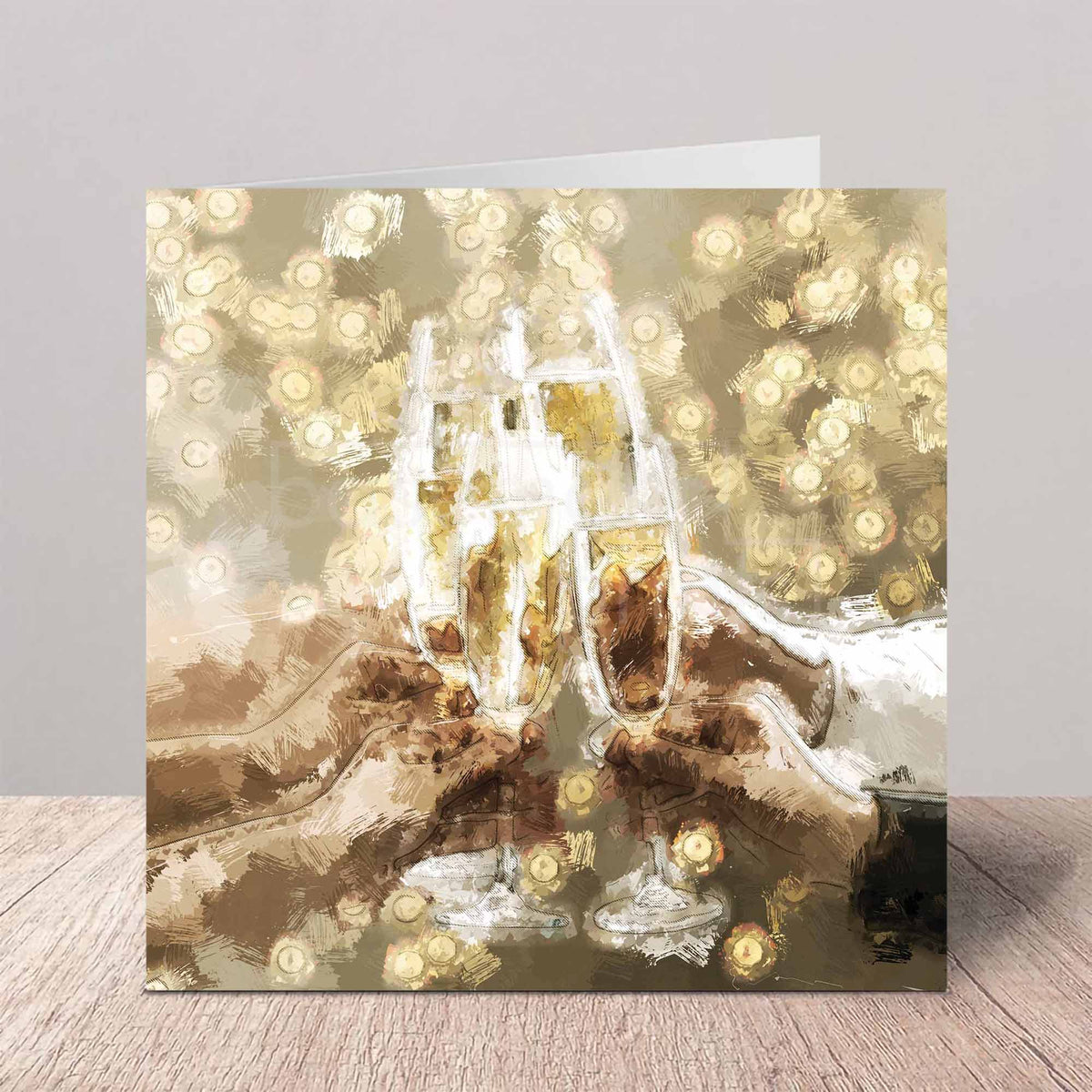 A square greeting card featuring an artistic, painterly depiction of four champagne flutes clinking and glowing bokeh lights, displayed on a light wood surface against a neutral gray background.