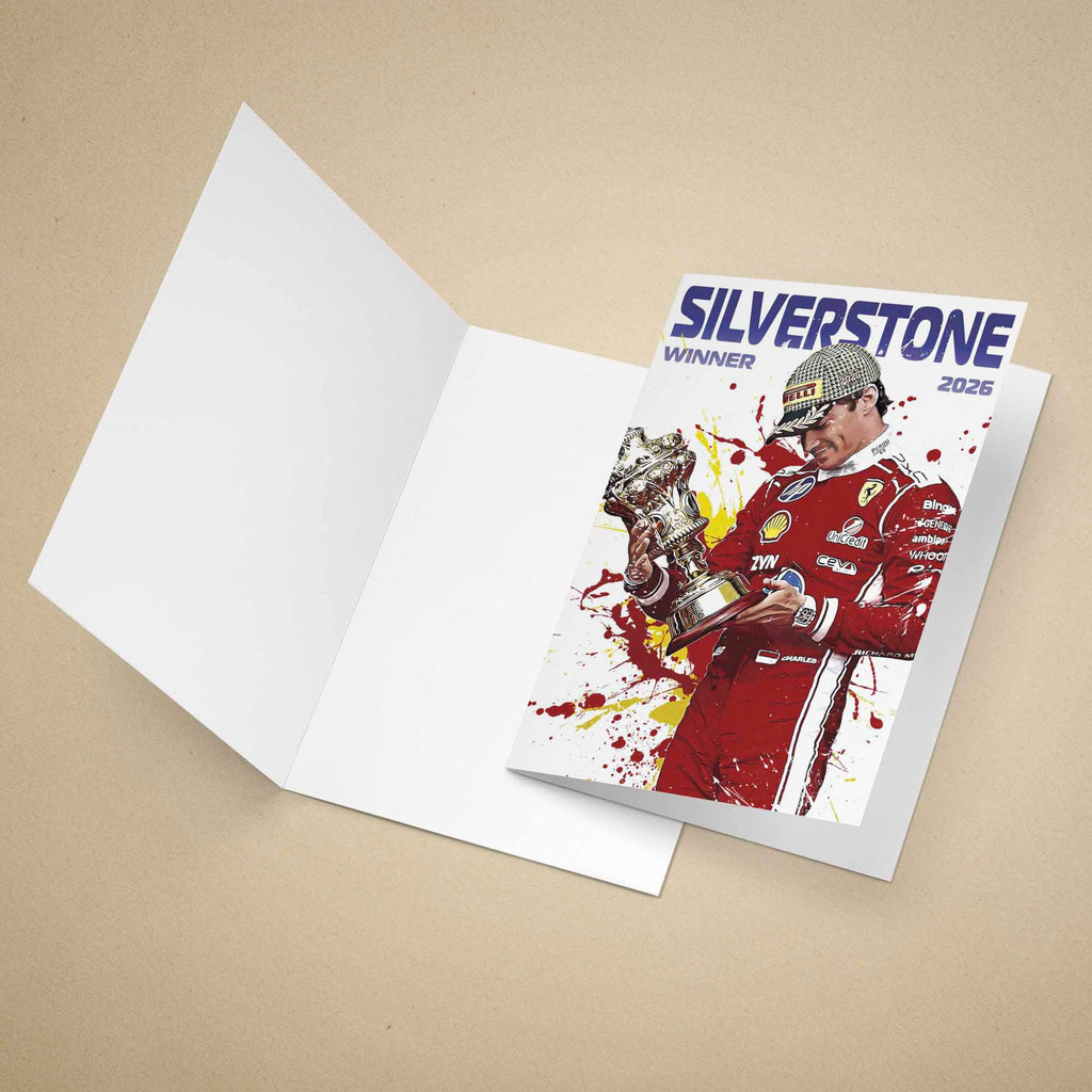 An open white greeting card lies on a beige background, with a printed insert card on top showing a racing-themed illustration of Charles Leclerc holding a trophy, with the text 'SILVERSTONE WINNER 2026'.