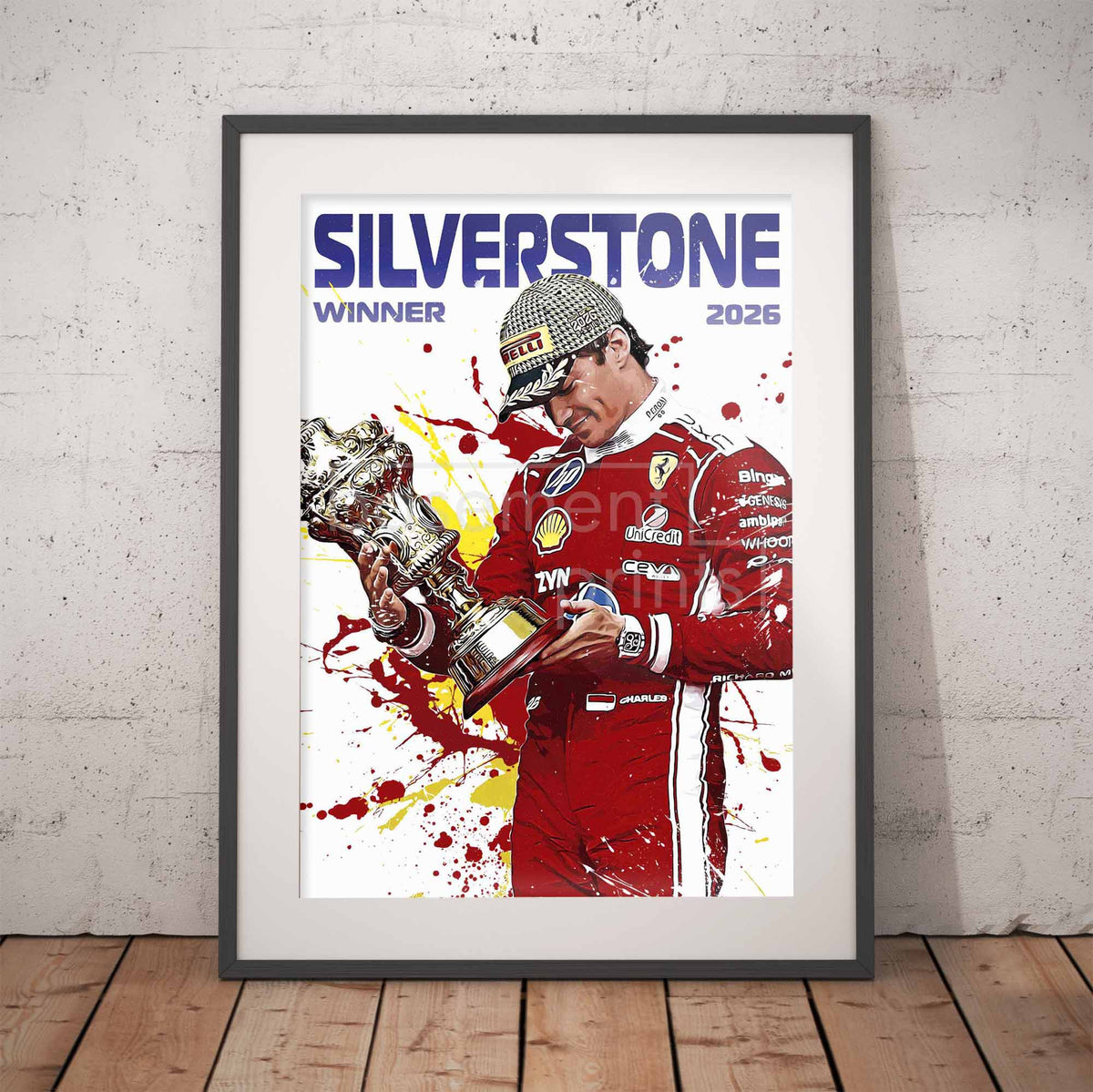 A Framed poster leaning against a brick wall, showing a Formula 1 illustration of Charles Leclerc holding a trophy, with the text 'SILVERSTONE WINNER 2026'.