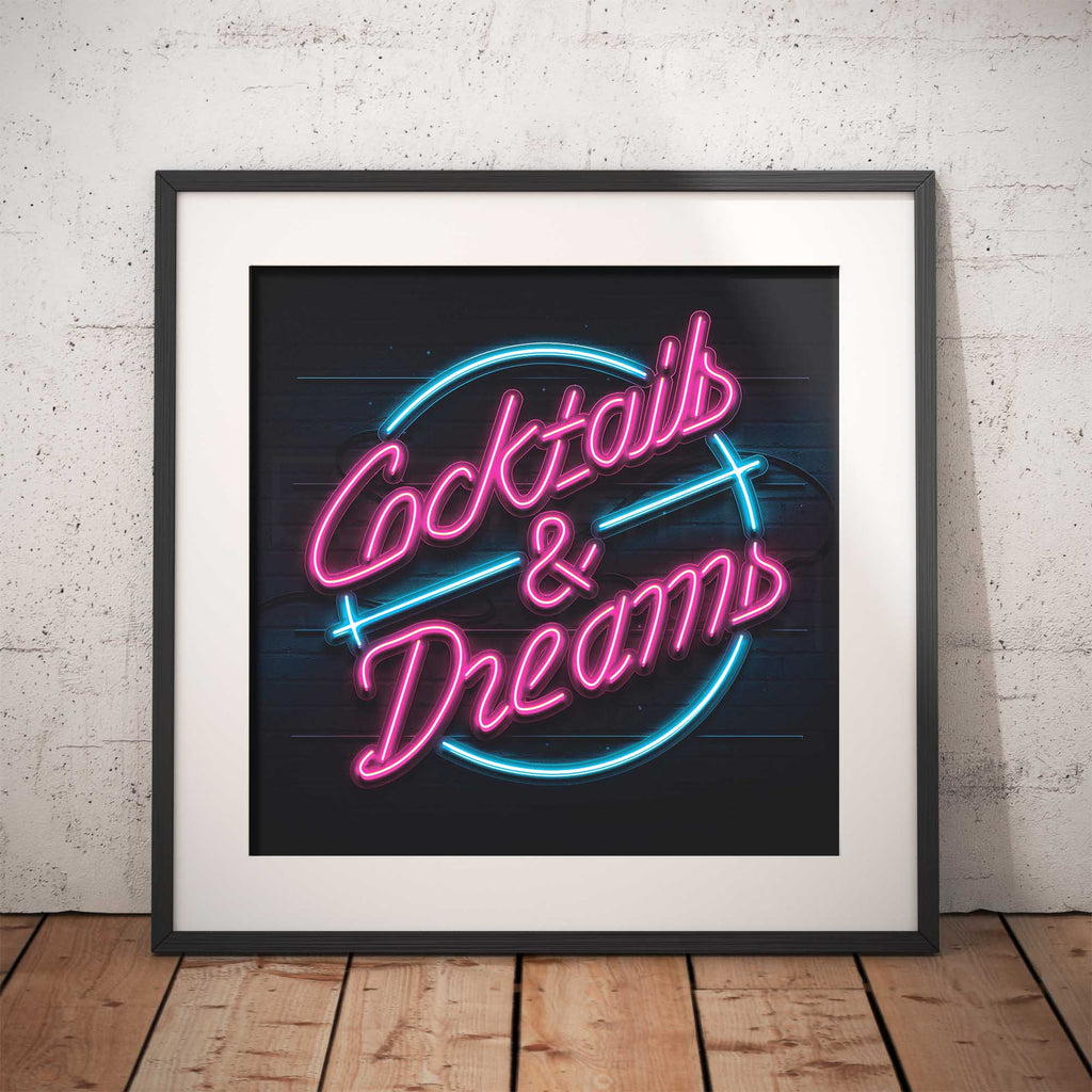 Framed neon-style artwork with 'Cocktails & Dreams' text on a brick wall background