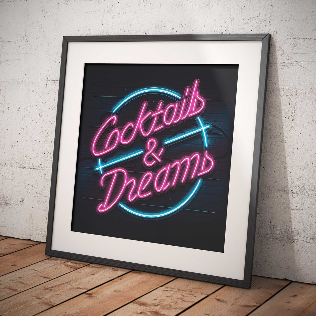 Framed neon sign with 'Cocktails & Dreams' text on a brick wall background