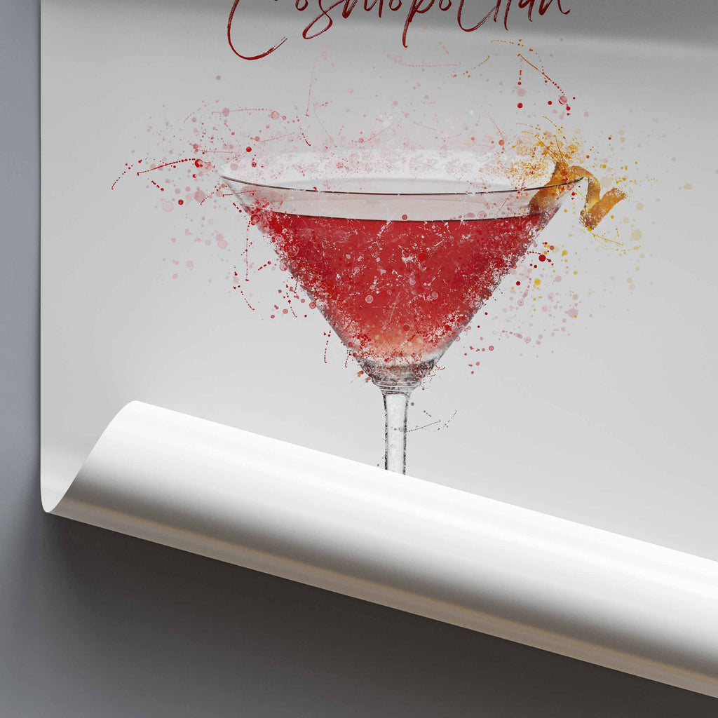 Art print of a Cosmopolitan cocktail in a martini glass with splashes on a gray background.