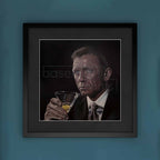 Framed artwork of a James Bond, Daniel Craig holding a cocktail glass on a blue background