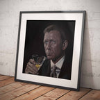 Framed artwork of James Bond, Daniel Craig holding a glass against a white brick wall.