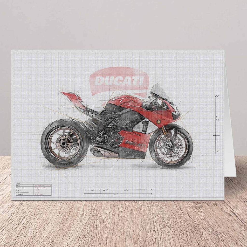 Agreeting card featuring a stylized Ducati motorcycle illustration on a white grid background, displayed standing on a light wood surface against a pale wall.