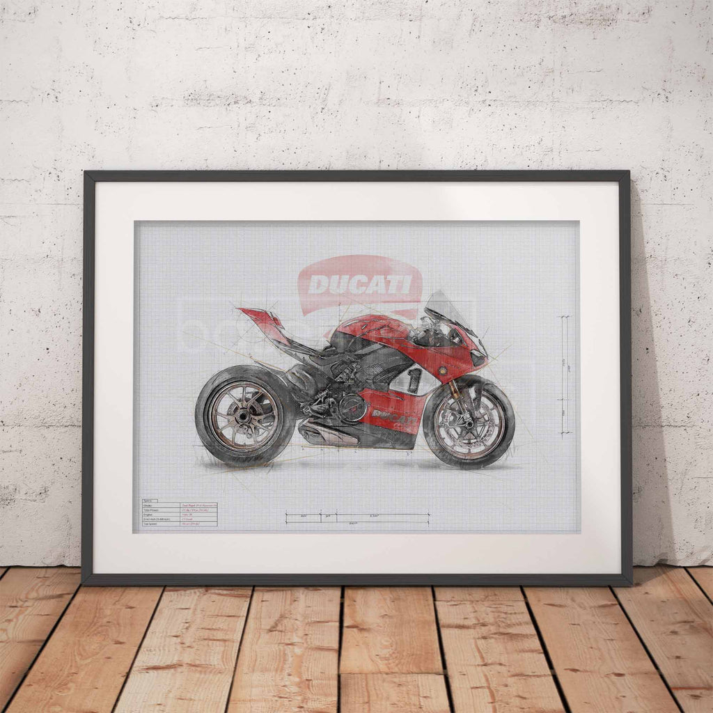 A framed art print of a red and black Ducati sport motorcycle on a blueprint-style background, leaning against a white brick wall on a wooden floor.