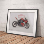 A framed art print of a red Ducati motorcycle, styled leaning against a textured light gray concrete wall on a light brown wooden floor.
