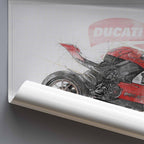 A rolled-up wall art print or poster showing a red and black Ducati sport motorcycle on a blueprint-style background, leaning against a white brick wall on a wooden floor.