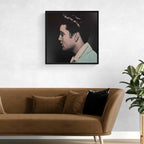 Framed portrait of Elvis Presley above a brown sofa with decorative pillows in a living room setting.