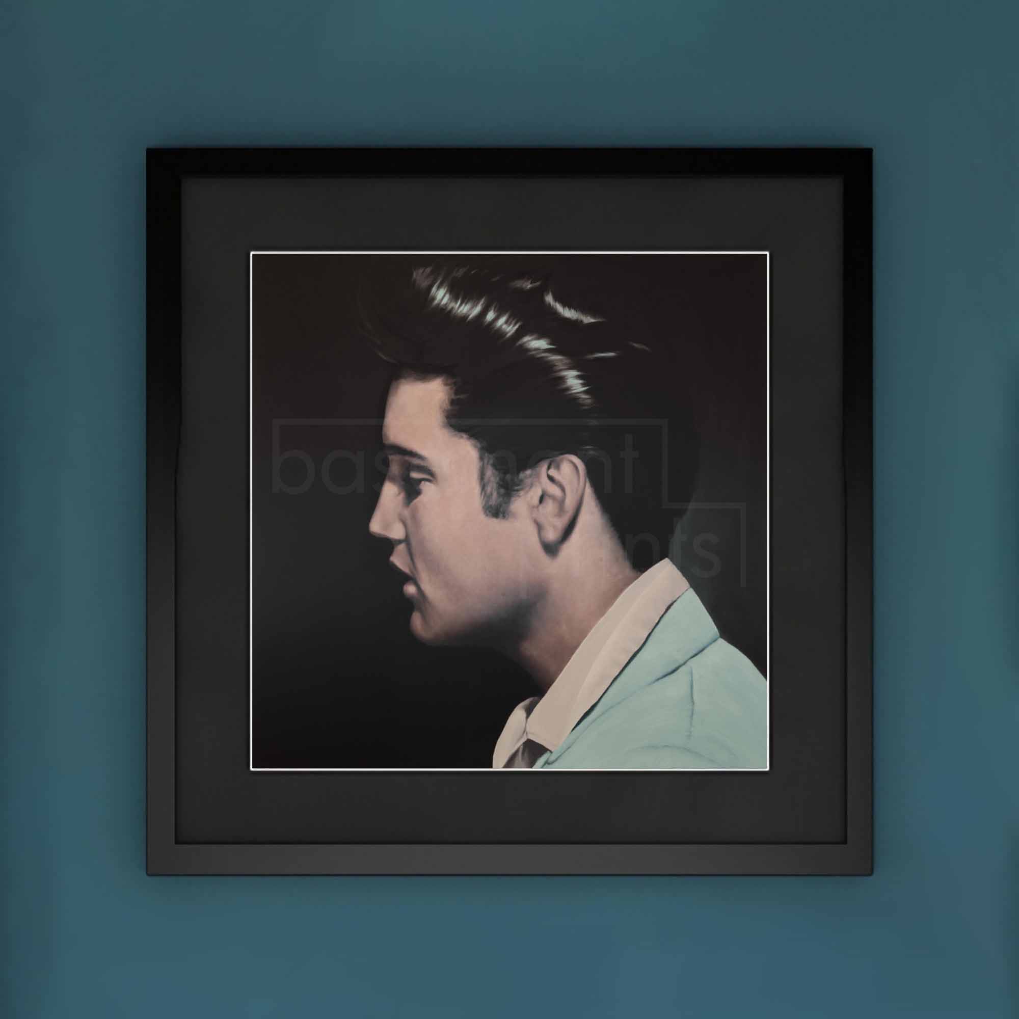 Framed portrait of Elvis Presley on a blue wall