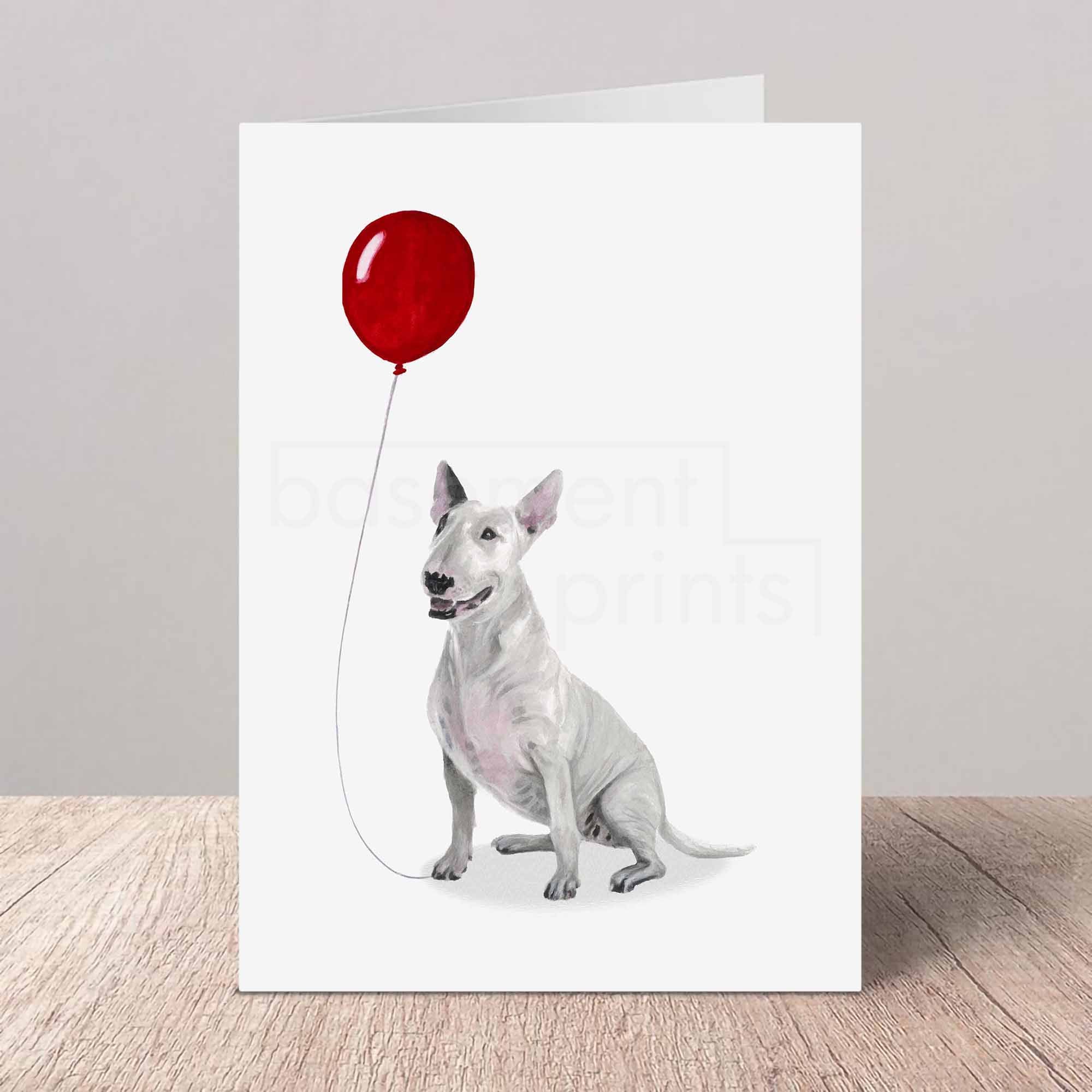 Greeting card with an English Bull Terrier holding a red balloon on a white background