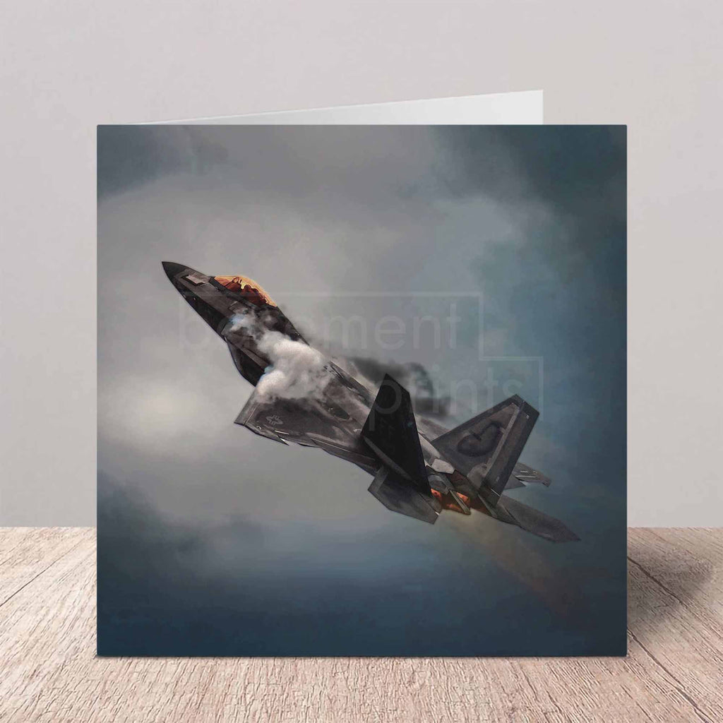 Greeting card of an F22 Raptor fighter jet in flight with a dark, stormy sky background